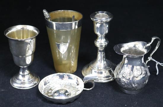 An Edwardian silver cream jug, a silver candlestick, cup, wine taster etc.